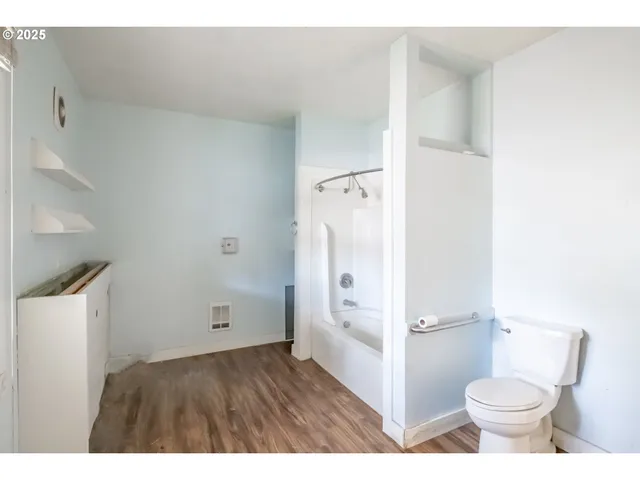 a bathroom with a toilet sink and a shower