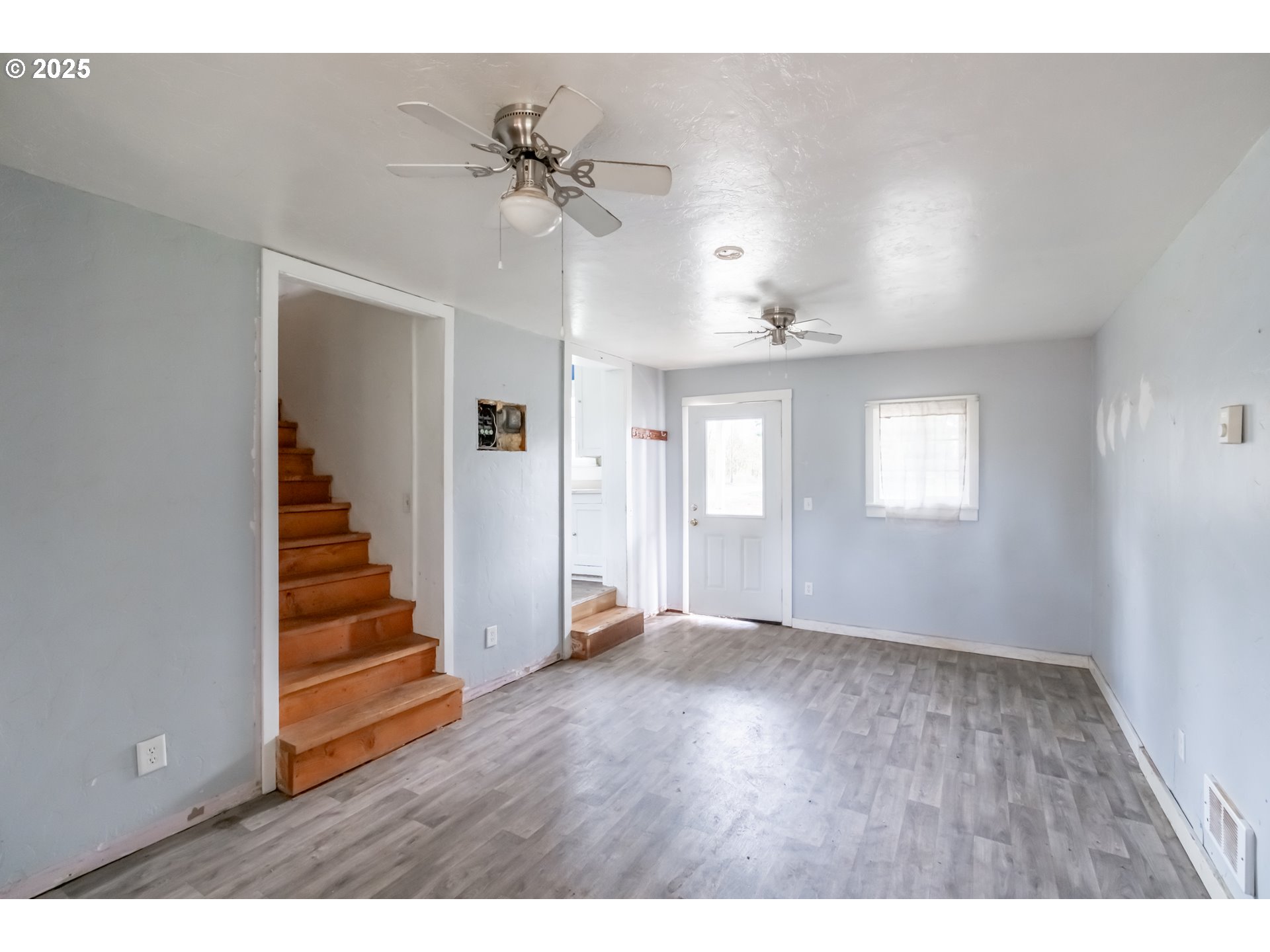 96470 Highway 99 Junction City, OR 97448 - Photo 22 of 48 a view of an empty room with wooden floor and staircase