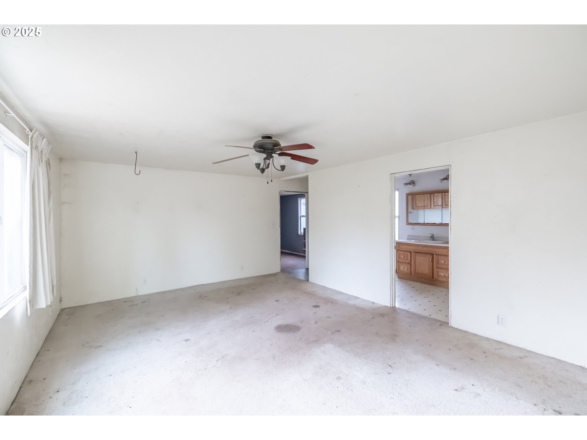 96470 Highway 99 Junction City, OR 97448 - Photo 40 of 48 an empty room with a ceiling fan and window
