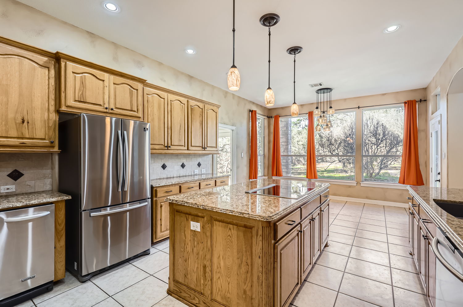 210 Amandas Way Leander, TX 78641 - Photo 16 of 38 Kitchen featuring light tile patterned floors, a kitchen island, light stone counters, stainless steel appliances, and backsplash