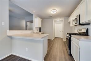 3210 Candlepine Drive Spring, TX 77388 - Photo 12 of 27 a kitchen with a sink a stove and cabinets