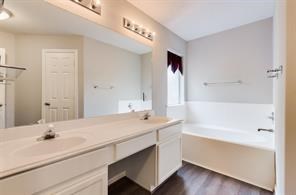 3210 Candlepine Drive Spring, TX 77388 - Photo 18 of 27 a bathroom with a tub sink and mirror