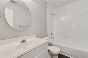 3210 Candlepine Drive Spring, TX 77388 - Photo 23 of 27 a bathroom with a sink a toilet and a mirror