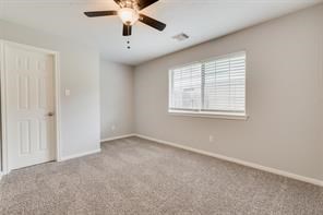 3210 Candlepine Drive Spring, TX 77388 - Photo 24 of 27 an empty room with windows and chandelier fan