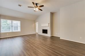 3210 Candlepine Drive Spring, TX 77388 - Photo 7 of 27 a view of an empty room with wooden floor and a window