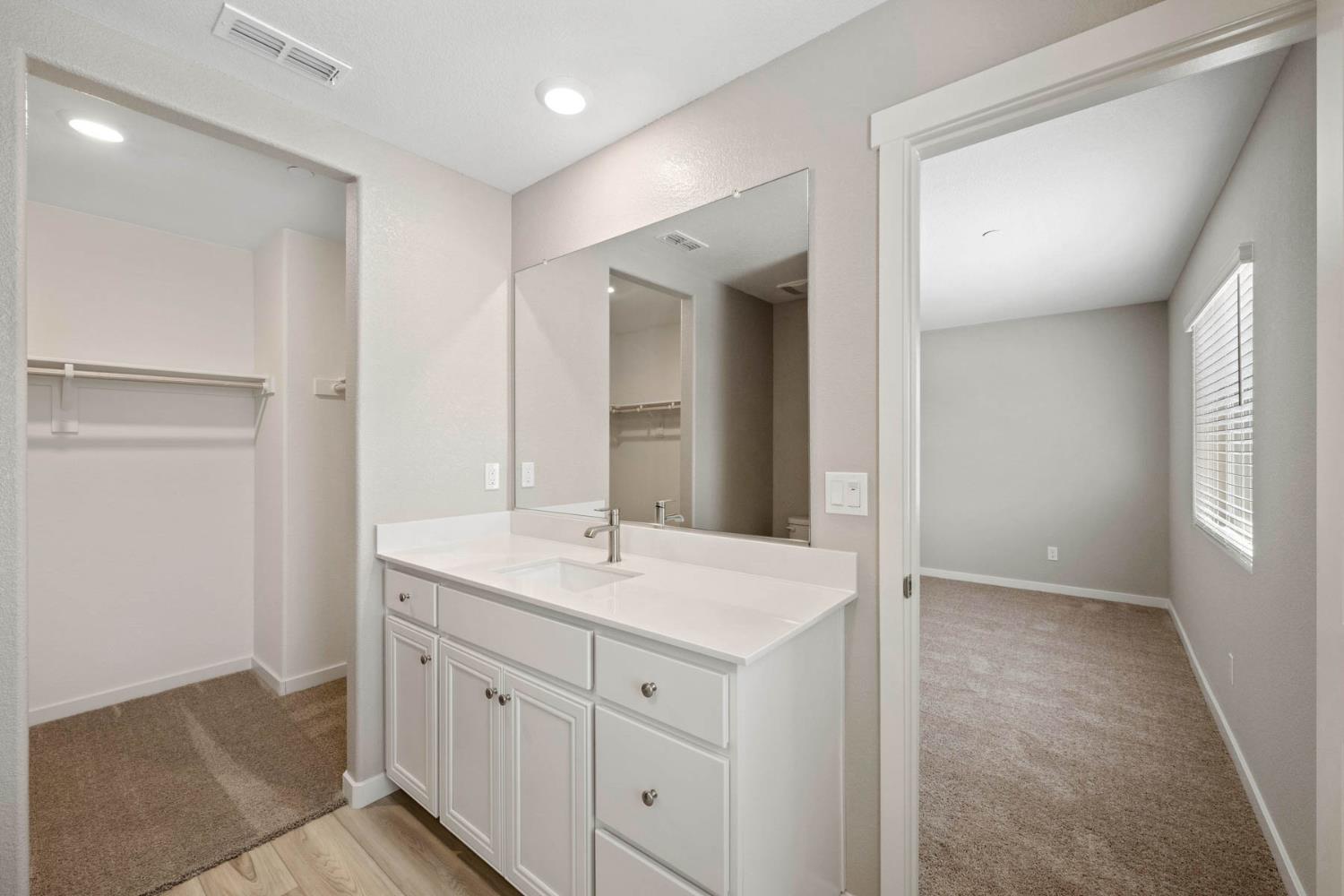 2972 Bowery Lane Lincoln, CA 95648 - Photo 16 of 23 a bathroom with a sink a mirror and a vanity