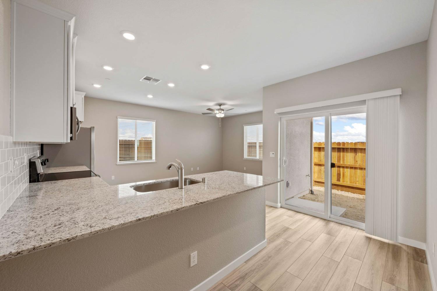 2972 Bowery Lane Lincoln, CA 95648 - Photo 3 of 23 a large kitchen with granite countertop a large window and a sink