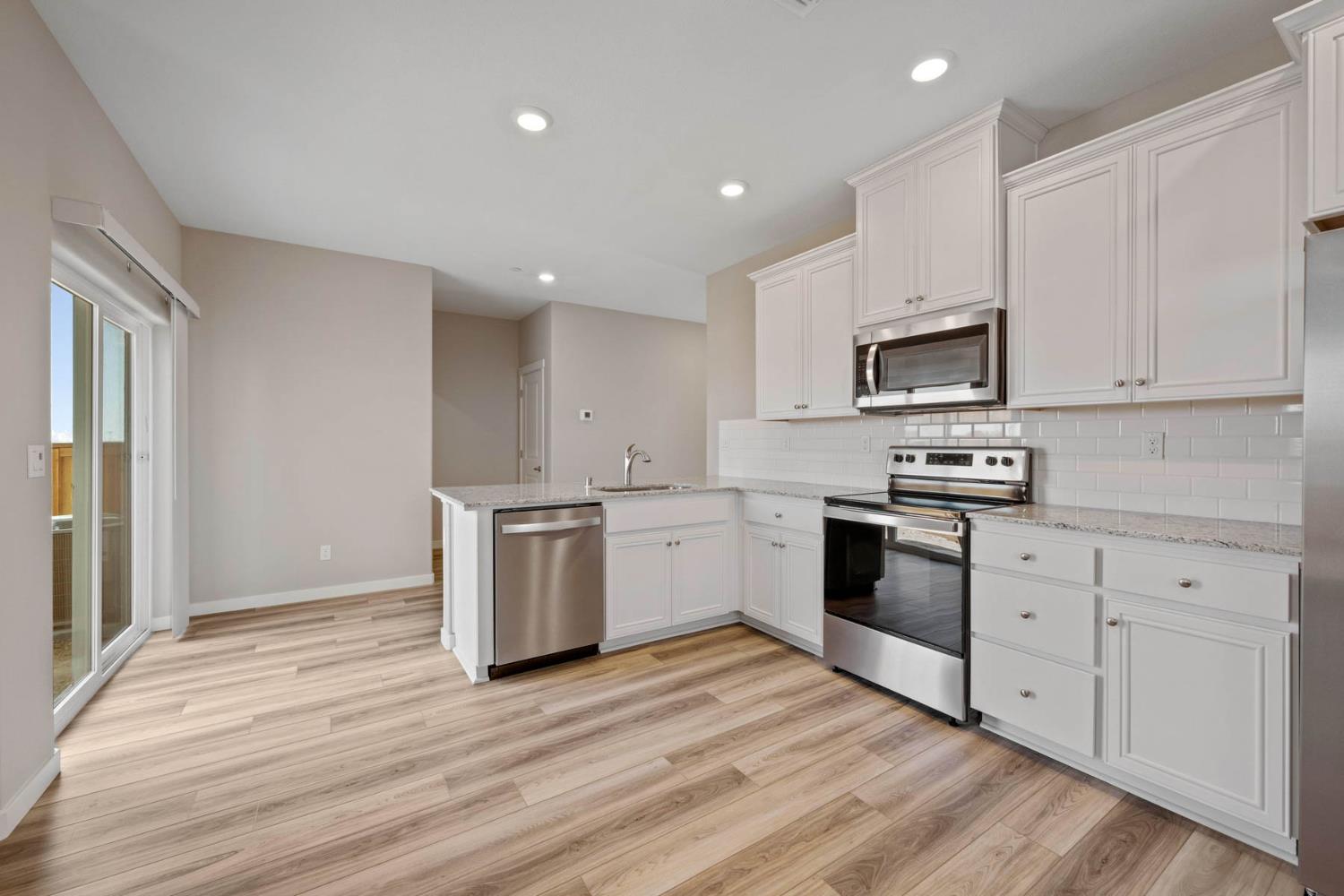 2972 Bowery Lane Lincoln, CA 95648 - Photo 6 of 23 a kitchen with a stove a sink and a microwave
