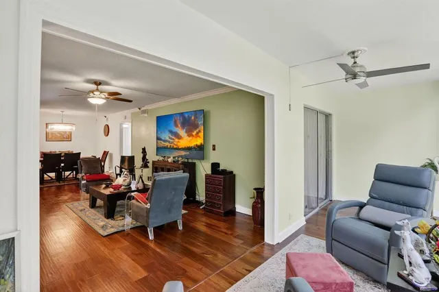 a living room with furniture ceiling fan and a rug