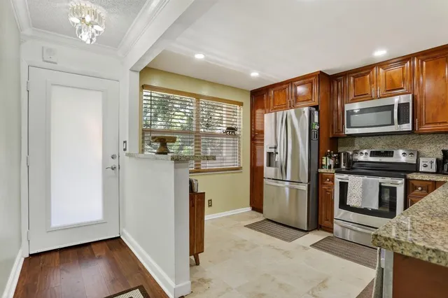a kitchen with a refrigerator sink and microwave