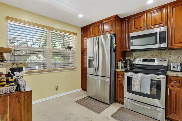 a metallic refrigerator freezer sitting in a kitchen