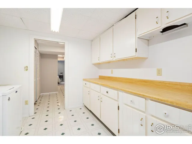 a utility room with cabinets washer and dryer
