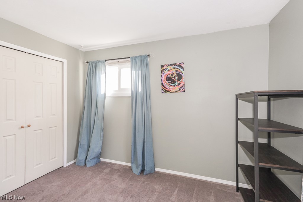 1127 Garden Road Willoughby, OH 44094 - Photo 14 of 33 Unfurnished bedroom featuring a closet and dark carpet