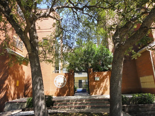 106 East 30th Street, Unit 101 Austin, TX 78705 - Photo 1 of 11 Back of property featuring brick siding and a gate