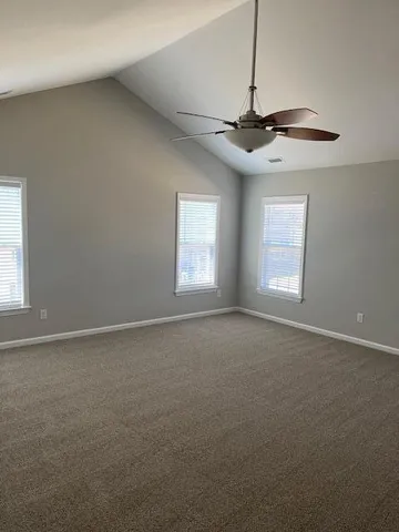 a bathroom with a granite countertop double vanity sink and a mirror