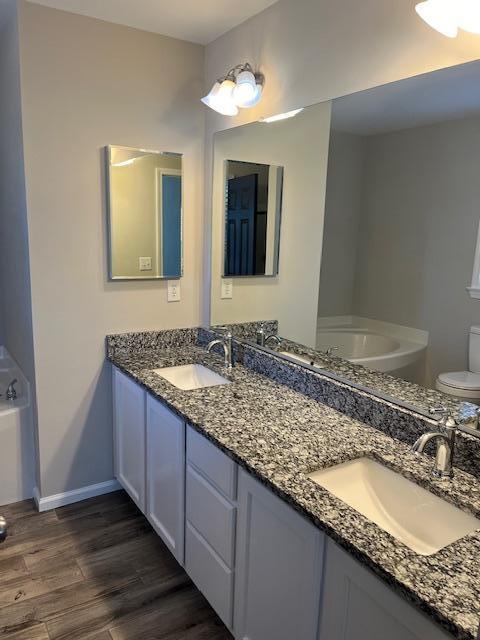 5405 Glass Ridge Road Raleigh, NC 27616 - Photo 14 of 18 a bathroom with a granite countertop double vanity sink and a mirror