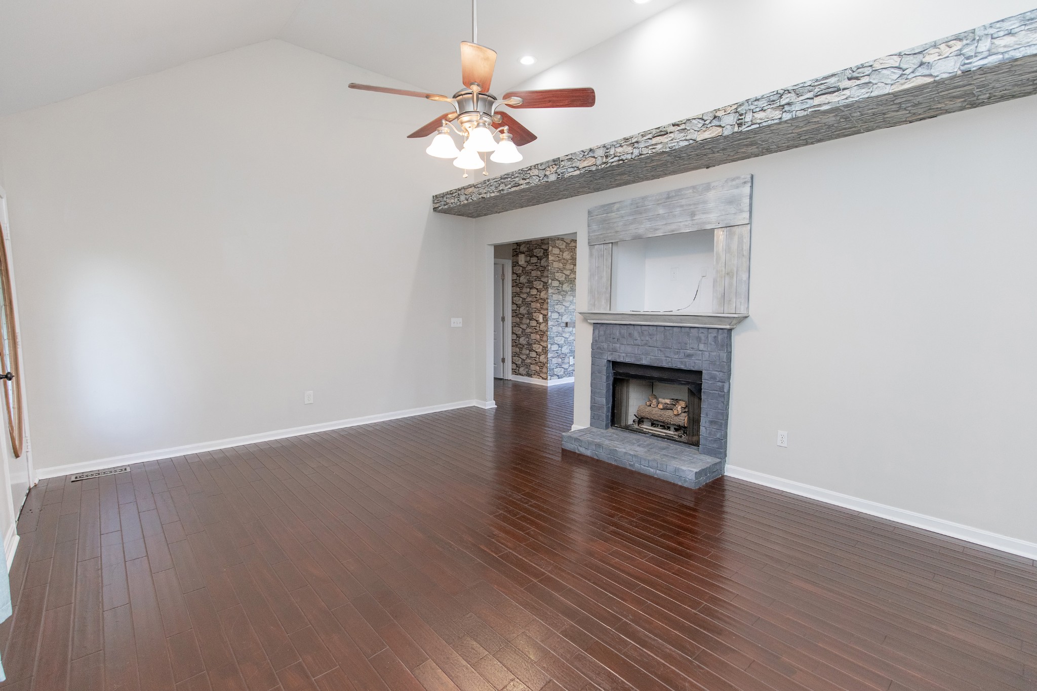 443 Clearview Road Cottontown, TN 37048 - Photo 4 of 21 a view of an empty room with wooden floor a fireplace and a window