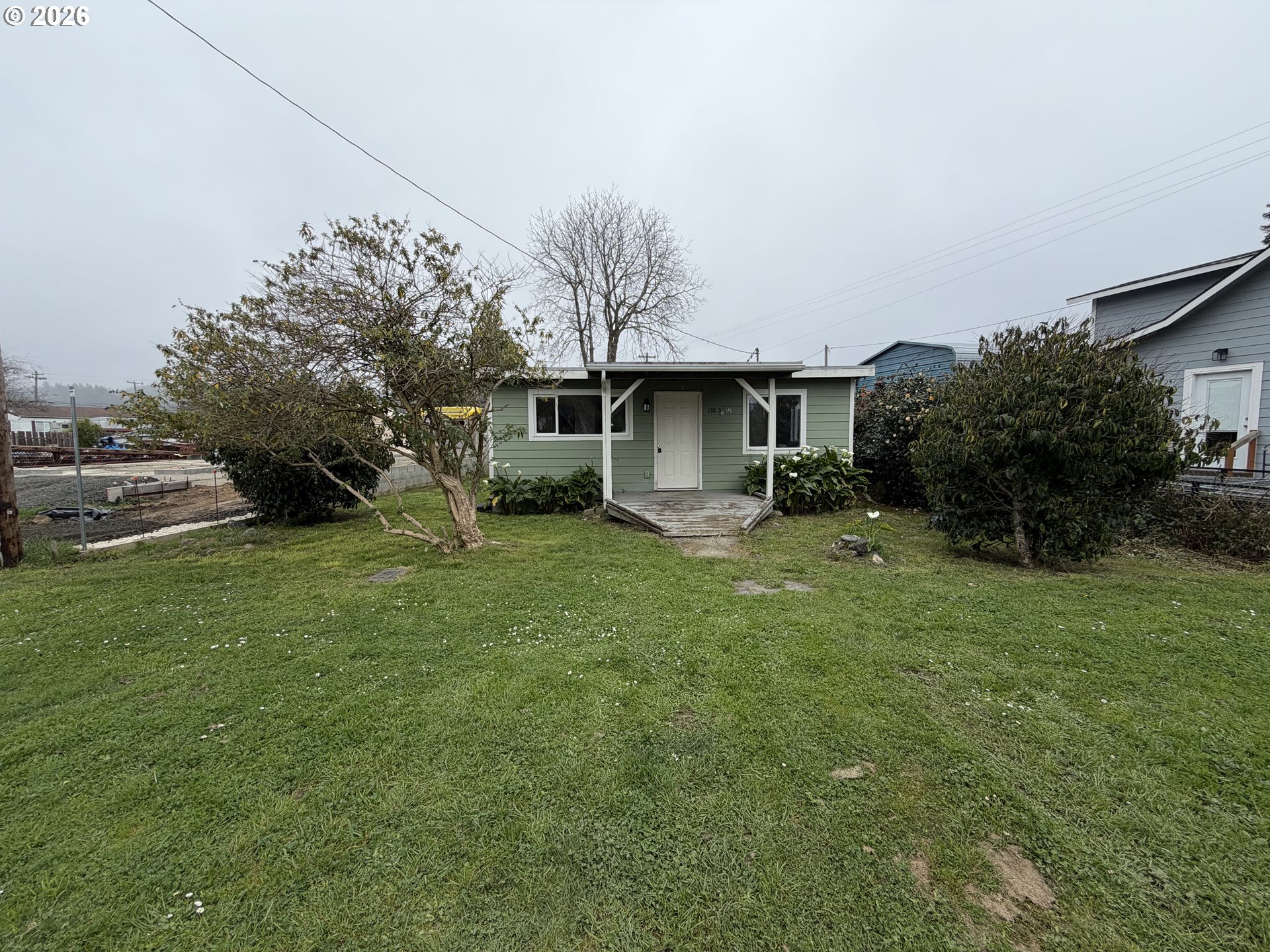 150 South 5th Street Lakeside, OR 97449 - Photo 11 of 19 a front view of house with yard and green space