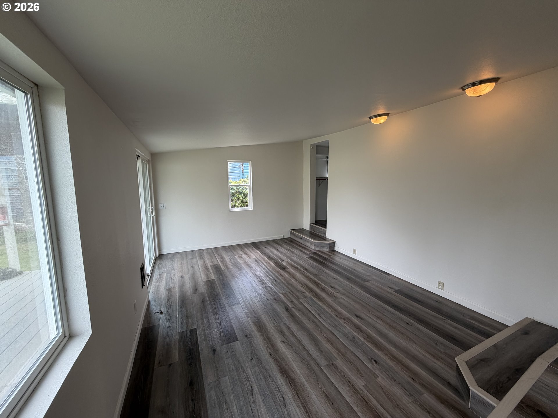150 South 5th Street Lakeside, OR 97449 - Photo 15 of 19 a view of wooden floor and windows in a room