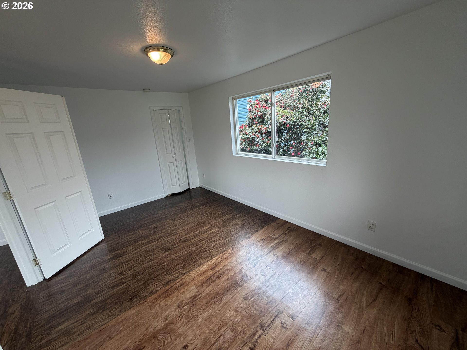 150 South 5th Street Lakeside, OR 97449 - Photo 2 of 19 an empty room with wooden floor and windows