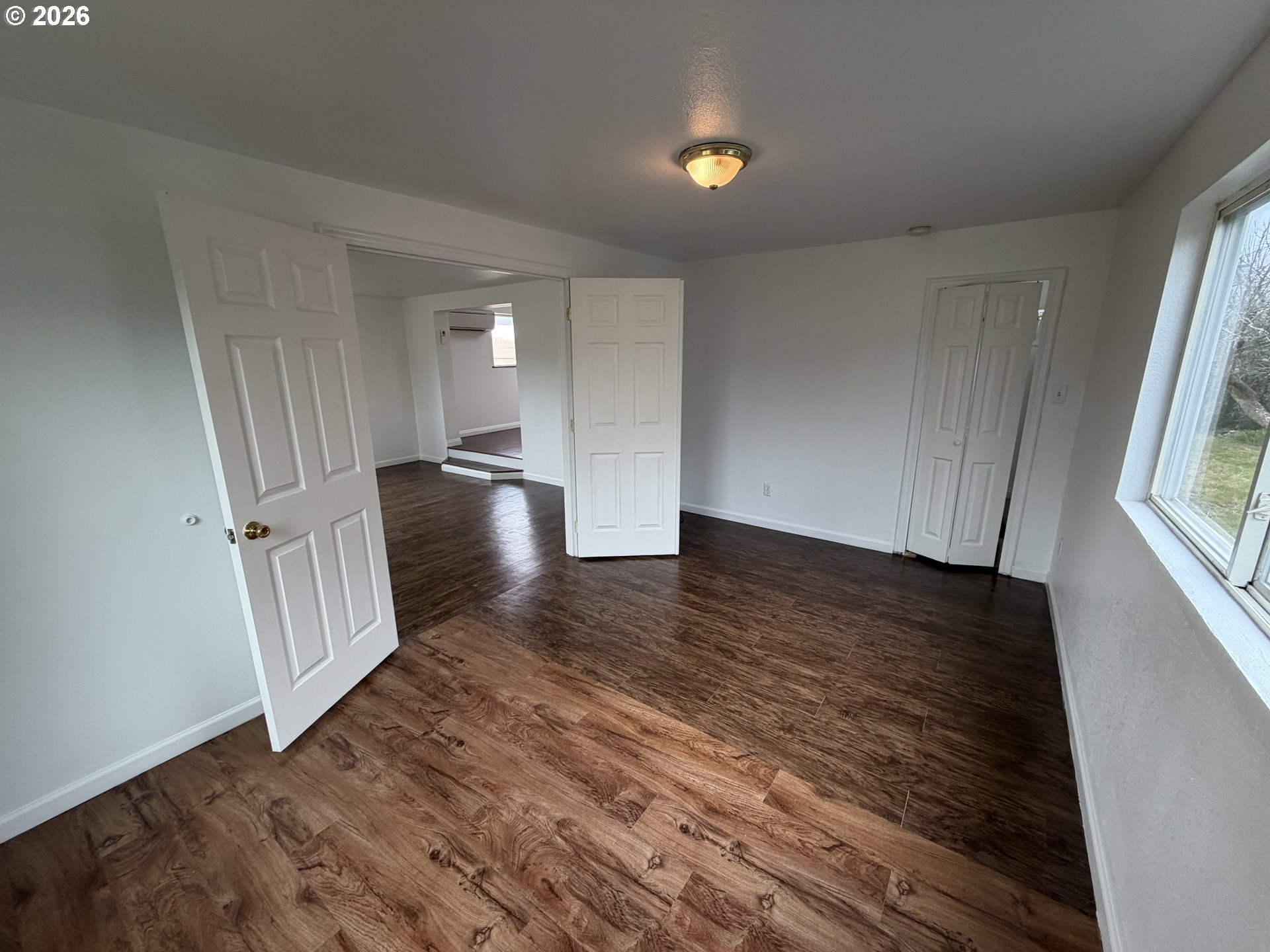 150 South 5th Street Lakeside, OR 97449 - Photo 3 of 19 a view of a livingroom with wooden floor and staircase