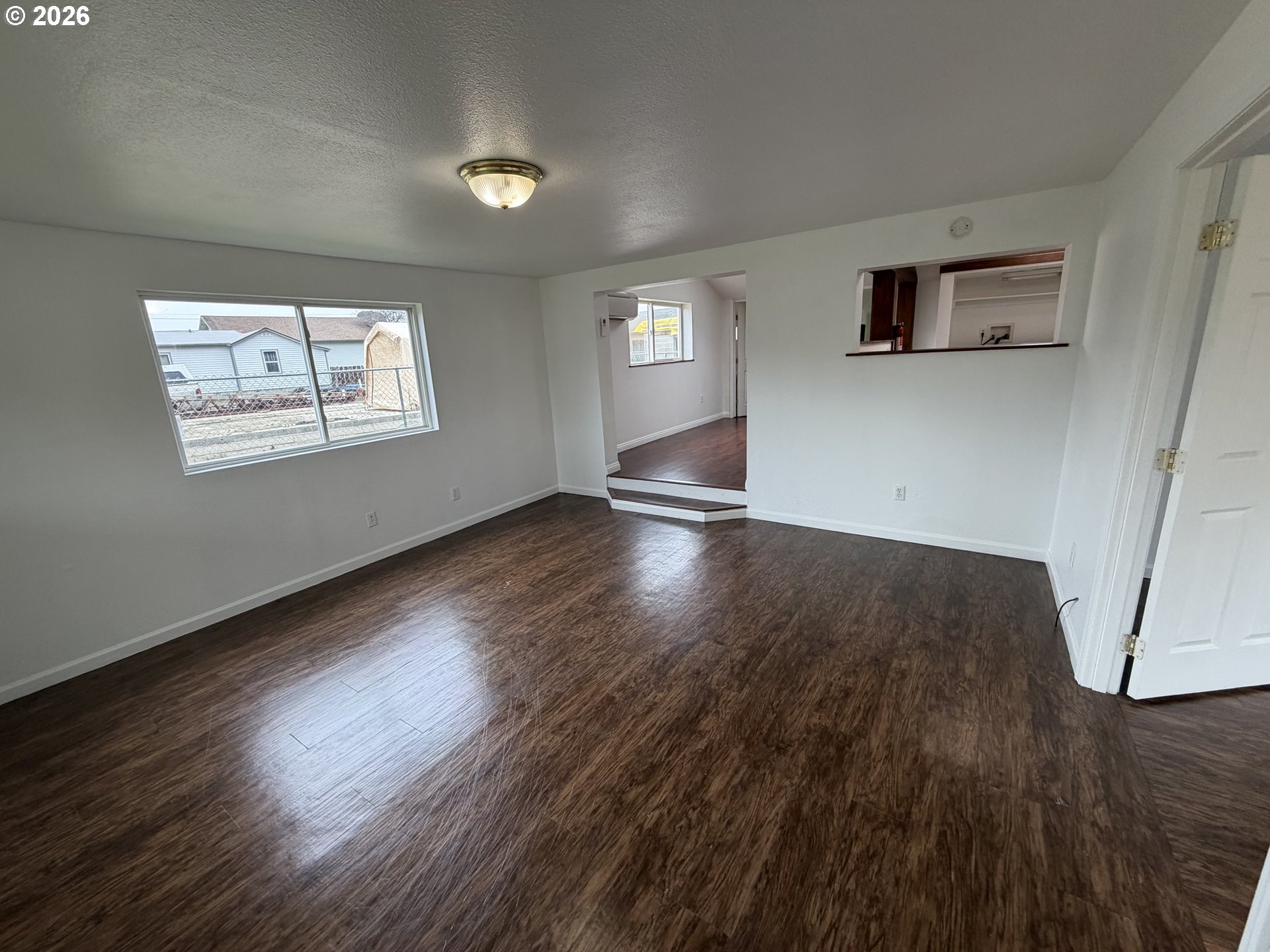 150 South 5th Street Lakeside, OR 97449 - Photo 4 of 19 an empty room with wooden floor and windows