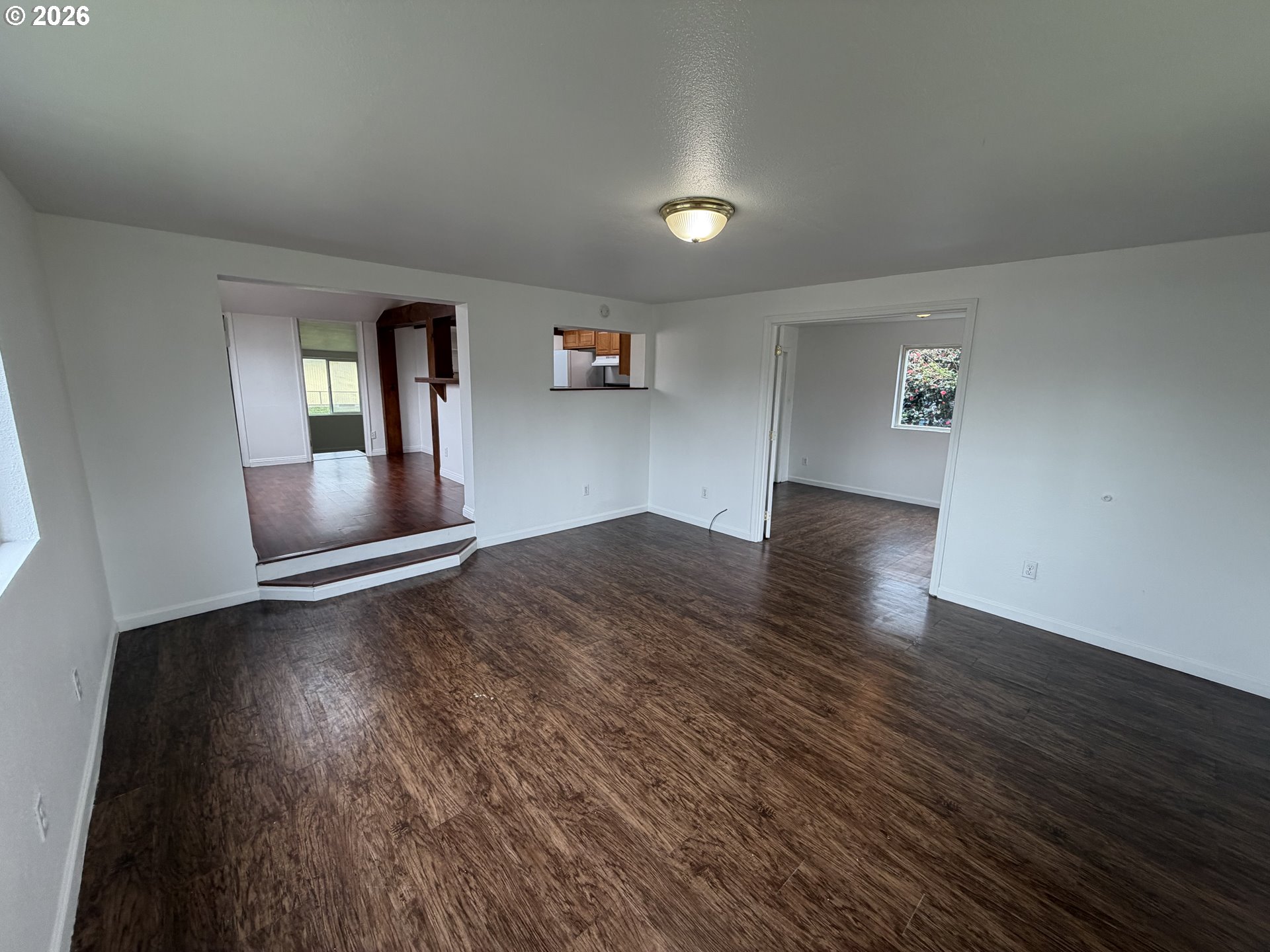 150 South 5th Street Lakeside, OR 97449 - Photo 5 of 19 an empty room with wooden floor and windows