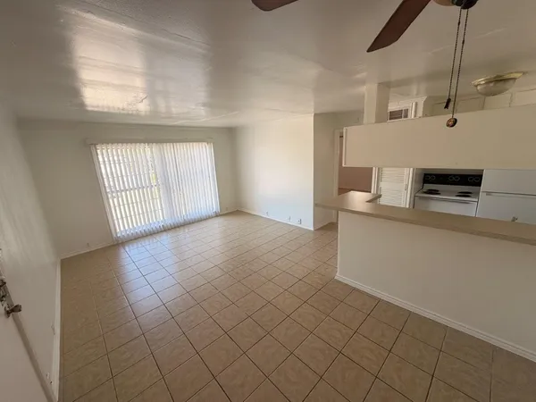 a view of a kitchen with a sink and dishwasher next to a window