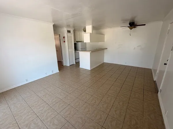 a view of a kitchen with white cabinets