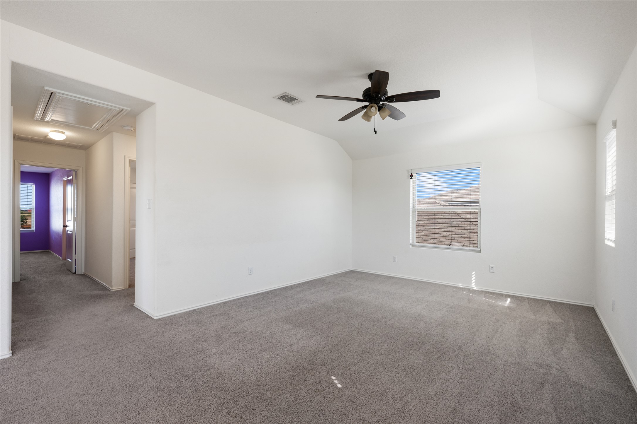 524 Circle Way, Unit 12F Jarrell, TX 76537 - Photo 24 of 34 Carpeted spare room featuring vaulted ceiling and ceiling fan
