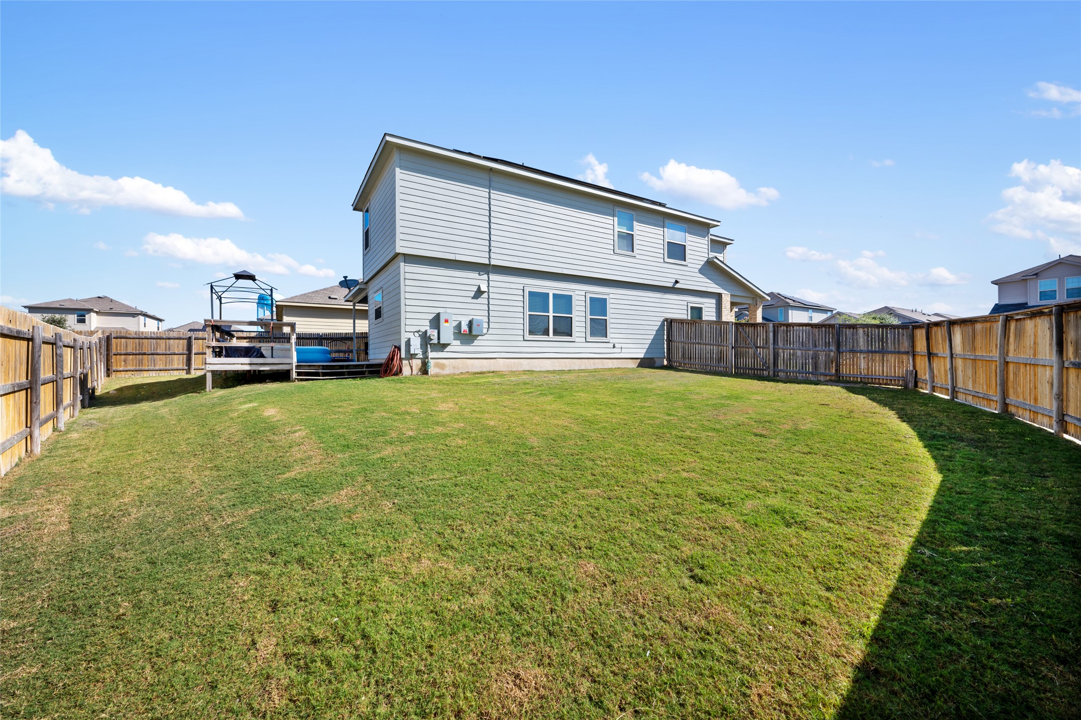 524 Circle Way, Unit 12F Jarrell, TX 76537 - Photo 33 of 34 Rear view of house with a deck and a fenced backyard