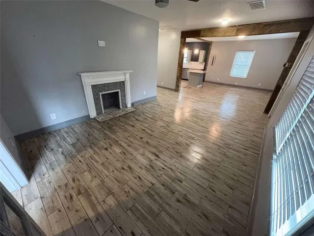 a view of an empty room and a fireplace