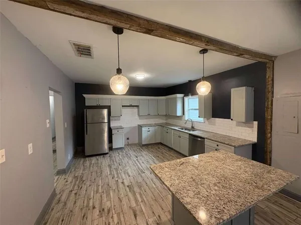 a kitchen with lots of counter space and appliances