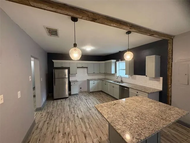 a kitchen with lots of counter space and appliances