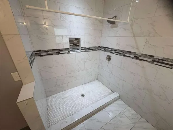 a bathroom with a shower and bathtub