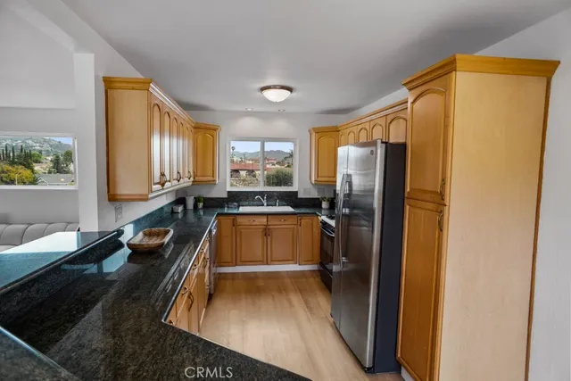 a kitchen with a refrigerator and a sink