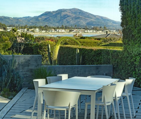 a view of a patio with a table chairs and a table