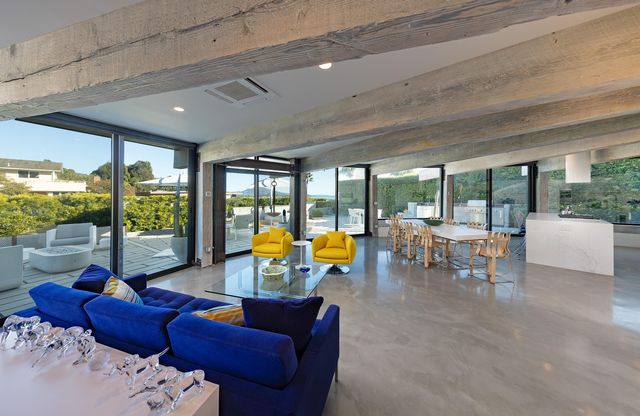 a living room with furniture and floor to ceiling windows