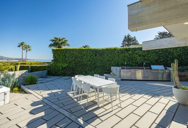 a view of a patio with table and chairs potted plants with wooden floor