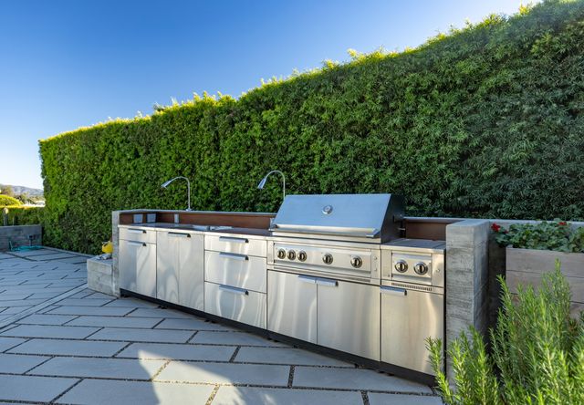 a stove top oven sitting next to a yard
