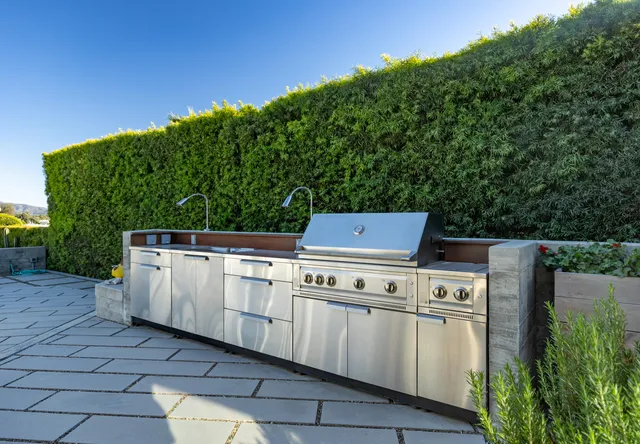 a stove top oven sitting next to a yard