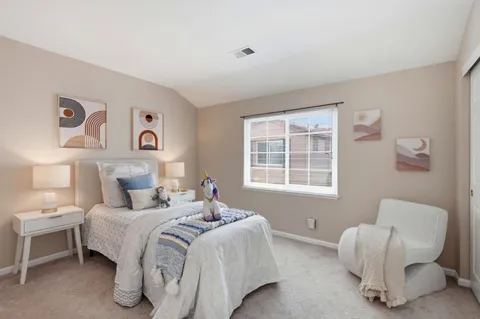a bedroom with a bed and a chair