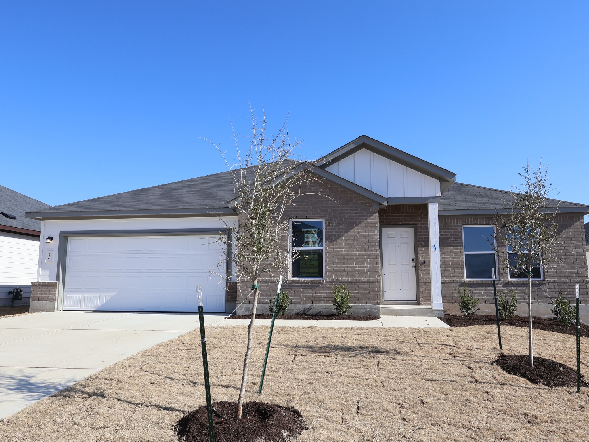 13701 Warnock Trail Manor, TX 78653 - Photo 1 of 22 a front view of a house with garden