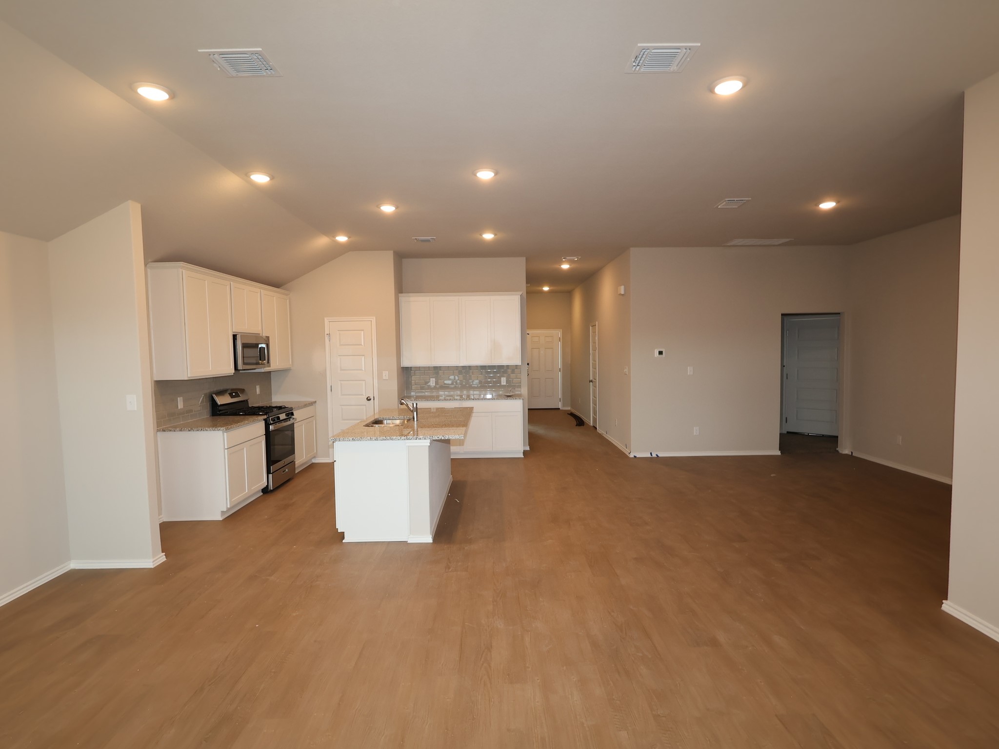 13701 Warnock Trail Manor, TX 78653 - Photo 2 of 22 a view of a kitchen with refrigerator and microwave