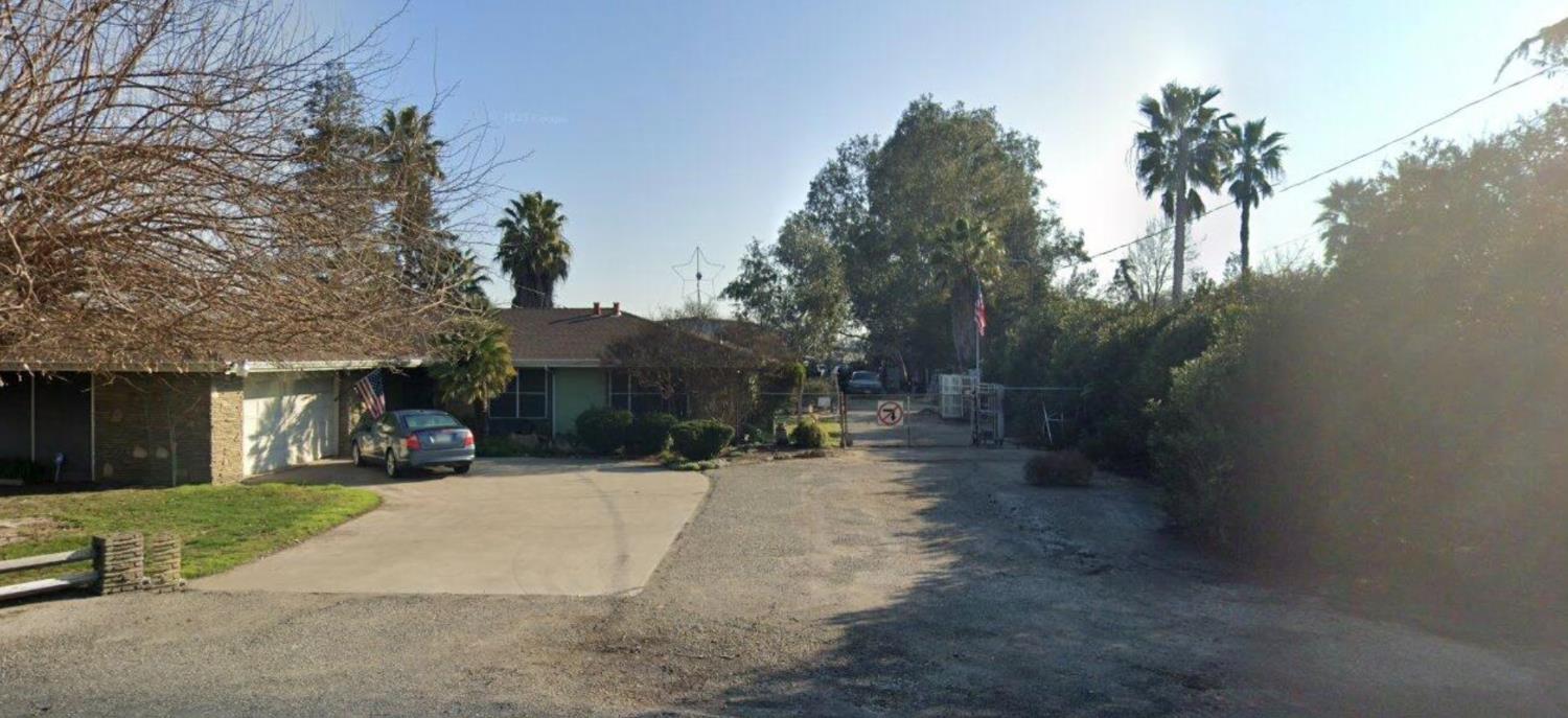 a view of a street with palm trees