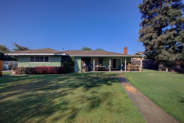 a front view of a house with a garden