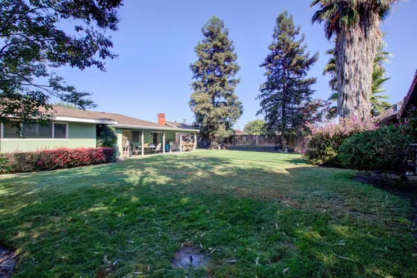 a front view of house with yard and trees