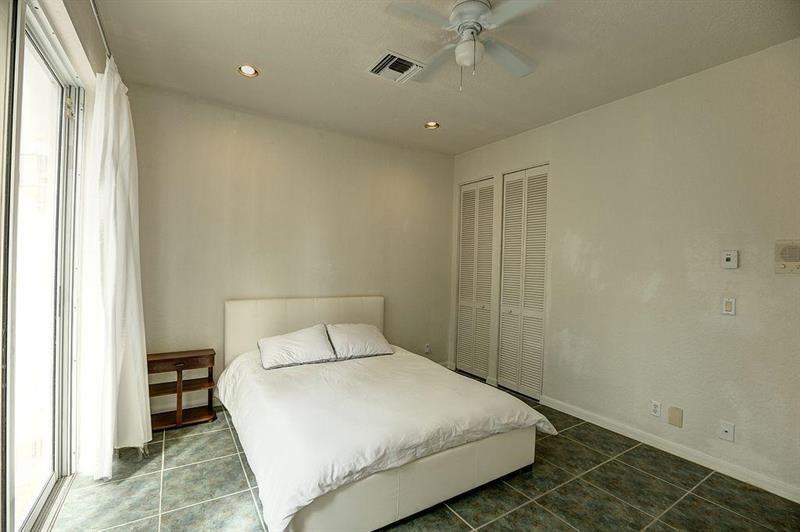 11230 Sea Grass Circle Boca Raton, FL 33498 - Photo 13 of 15 a bedroom with a bed and a window