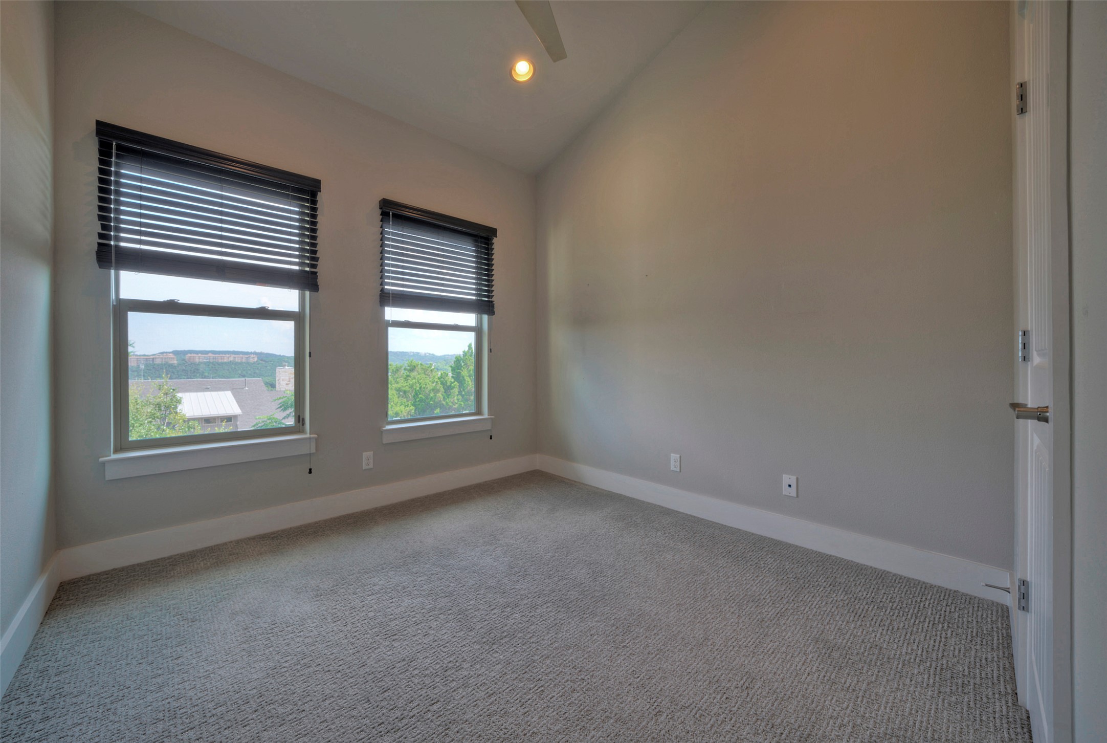 8110 Southeast Ranch Road 2222, Unit 98 Austin, TX 78730 - Photo 17 of 31 High vaulted ceilings and soft carpeting define this inviting secondary bedroom space.