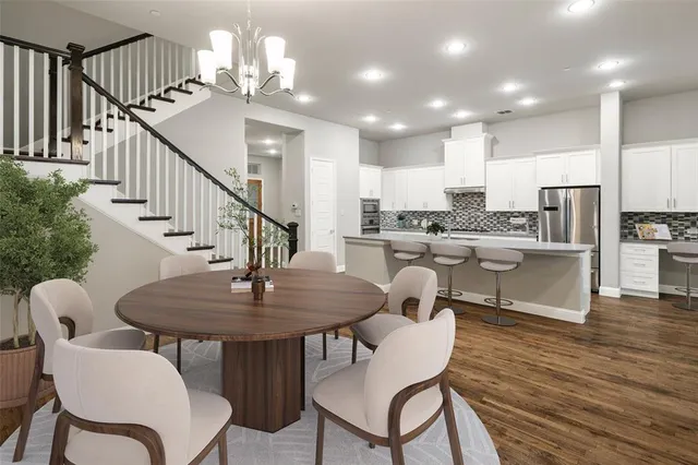 a dining room with furniture and wooden floor